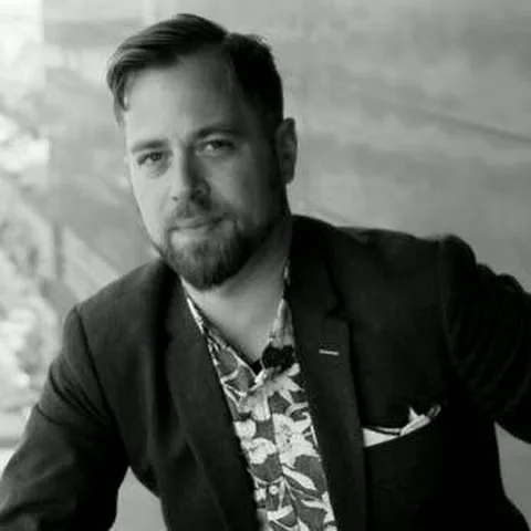 Black-and-white editorial portrait of Jared in a blazer.