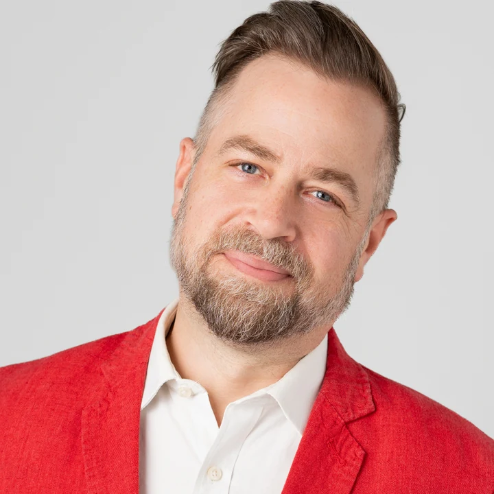 Jared Lukes, applied AI consultant and fractional leader, in a red blazer.